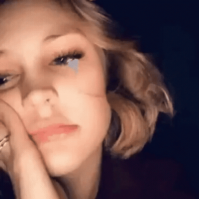 A Close Up Of A Woman With A Tear Coming Out Of Her Eye . GIF