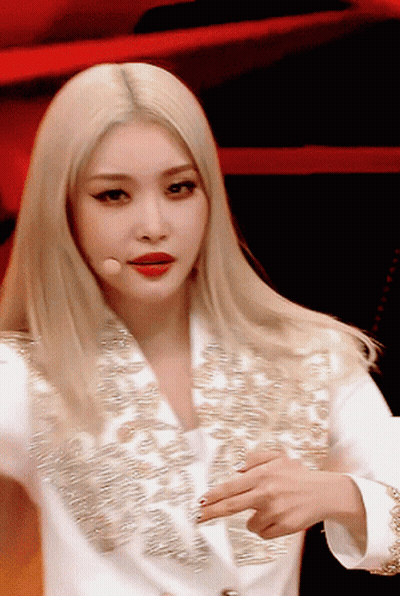A Close Up Of A Woman With Blonde Hair Wearing A White Jacket GIF