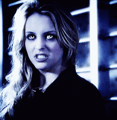 A Close Up Of A Woman With Glowing Eyes GIF