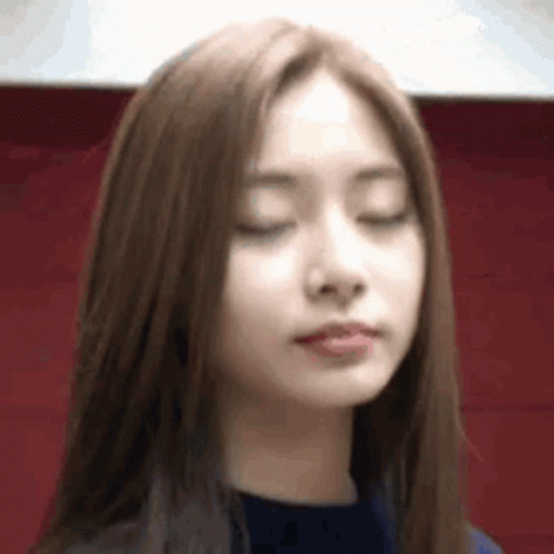 A Close Up Of A Woman With Her Eyes Closed And Her Mouth Open . GIF