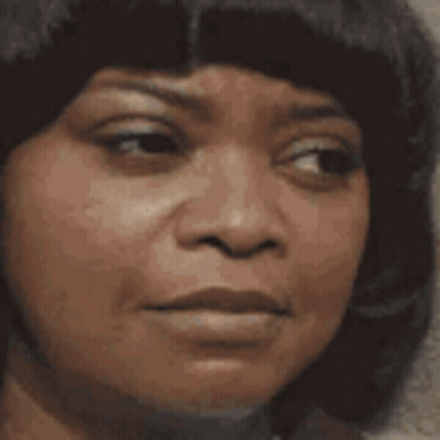 a close up of a woman with her eyes closed smiling .