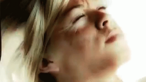 A Close Up Of A Woman With Her Eyes Closed . GIF