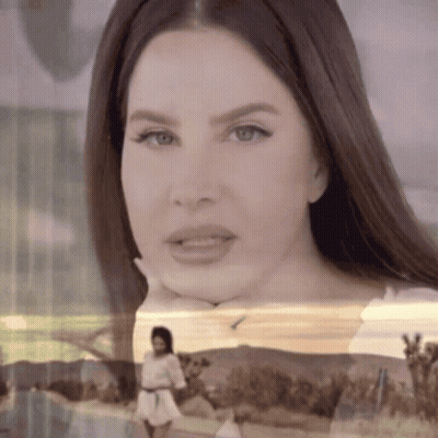 A Close Up Of A Woman With Her Hand On Her Chin GIF