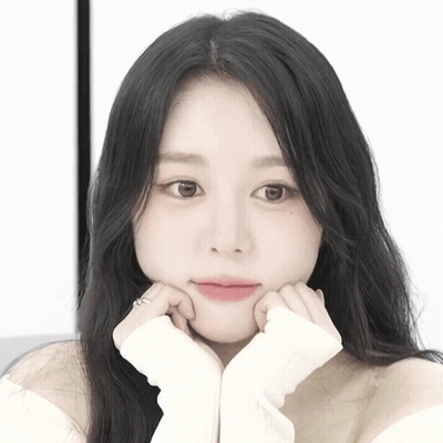 A Close Up Of A Woman With Her Hands On Her Chin GIF
