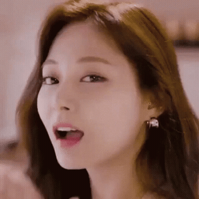 A Close Up Of A Woman With Her Mouth Open And Earrings . GIF