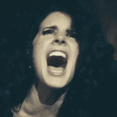 A Close Up Of A Woman With Her Mouth Open . GIF