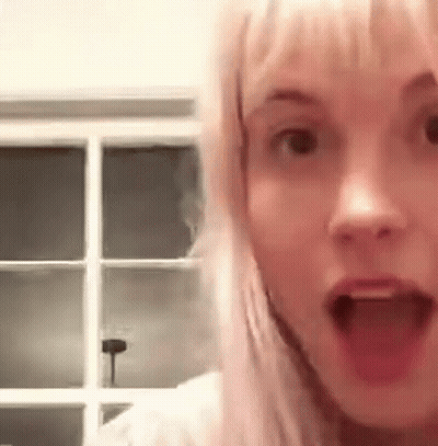 A Close Up Of A Woman With Her Mouth Open . GIF