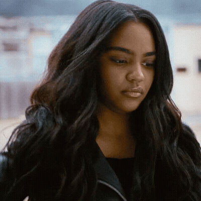 A Close Up Of A Woman With Long Black Hair Wearing A Black Jacket . GIF