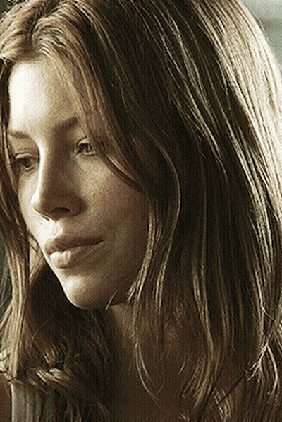 A Close Up Of A Woman With Long Brown Hair GIF