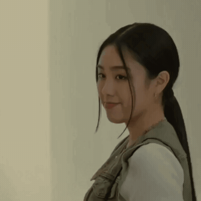 A Close Up Of A Woman With Long Hair In A Ponytail . GIF