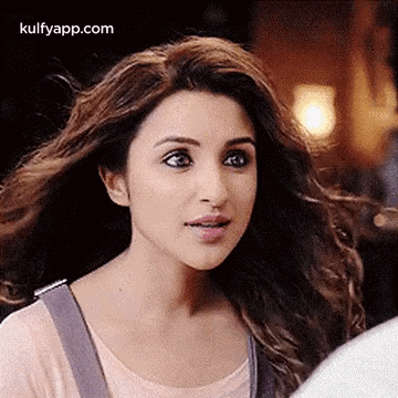 A Close Up Of A Woman With Long Hair Looking At The Camera . GIF