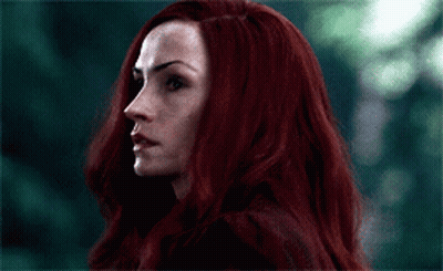 A Close Up Of A Woman With Long Red Hair GIF