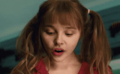 A Close Up Of A Woman With Pigtails And A Surprised Look On Her Face GIF