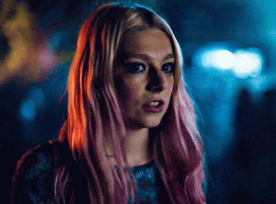 A Close Up Of A Woman With Pink Hair And Blue Eyes GIF