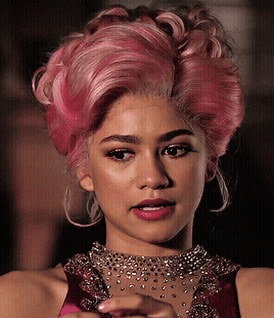 A Close Up Of A Woman With Pink Hair GIF