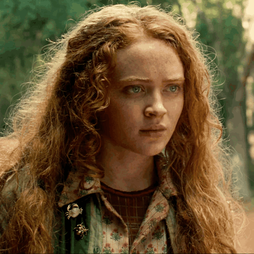 A Close Up Of A Woman With Red Hair GIF