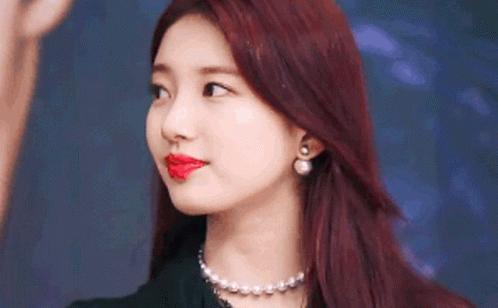 A Close Up Of A Woman With Red Hair And Red Lipstick . GIF