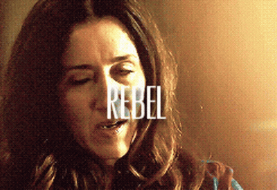 A Close Up Of A Woman With The Word Rebel Written On Her Face GIF