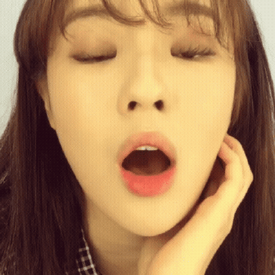 A Close Up Of A Woman Yawning With Her Mouth Wide Open GIF