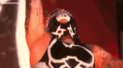 A Close Up Of A Wrestler 'S Face With A Mask On His Face GIF