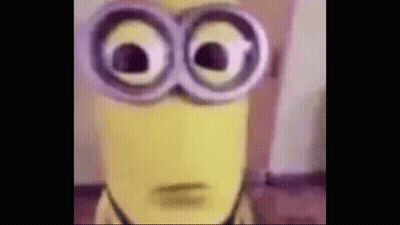 A Close Up Of A Yellow Minion Wearing Glasses . GIF