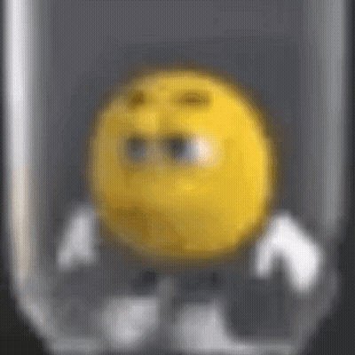 A Close Up Of A Yellow Smiley Face In A Glass GIF