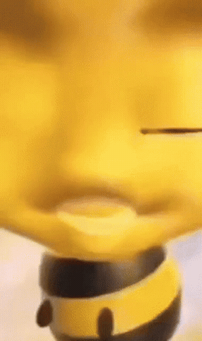 A Close Up Of A Yellow Toy That Looks Like A Bee Spinning On A Spinning Top . GIF