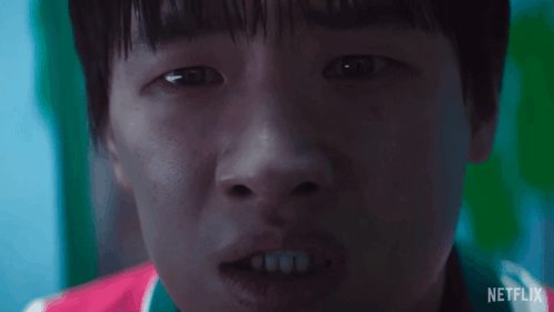 A Close Up Of A Young Boy 'S Face With A Netflix Logo In The Background . GIF