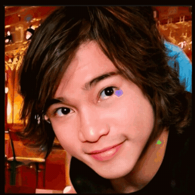 A Close Up Of A Young Boy 'S Face With A Purple Heart On His Eye GIF