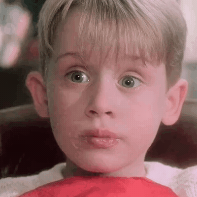 A Close Up Of A Young Boy 'S Face With A Red Scarf Around His Neck And Mouth . GIF