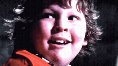 A Close Up Of A Young Boy 'S Face With His Mouth Open And His Teeth Missing . GIF