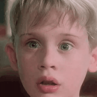 A Close Up Of A Young Boy 'S Face With His Mouth Open . GIF