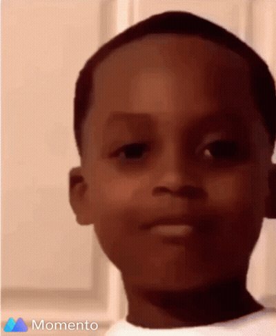 A Close Up Of A Young Boy 'S Face With The Words Momento On The Bottom GIF