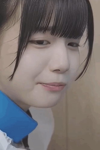 A Close Up Of A Young Girl 'S Face With A Blue Collar . GIF