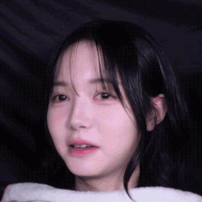 A Close Up Of A Young Girl 'S Face With A White Towel Around Her Neck GIF