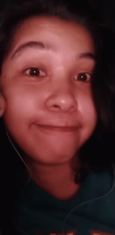 A Close Up Of A Young Girl 'S Face With Headphones On . GIF