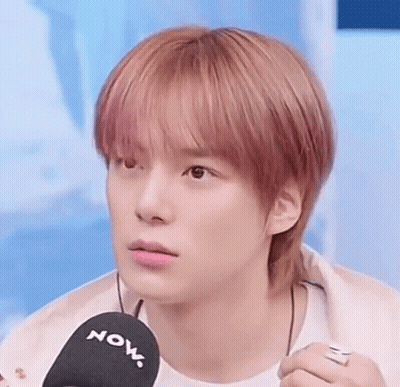 A Close Up Of A Young Man Holding A Microphone . GIF