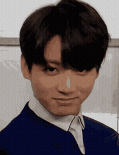 A Close Up Of A Young Man Making A Funny Face While Wearing A Blue Jacket And White Shirt . GIF
