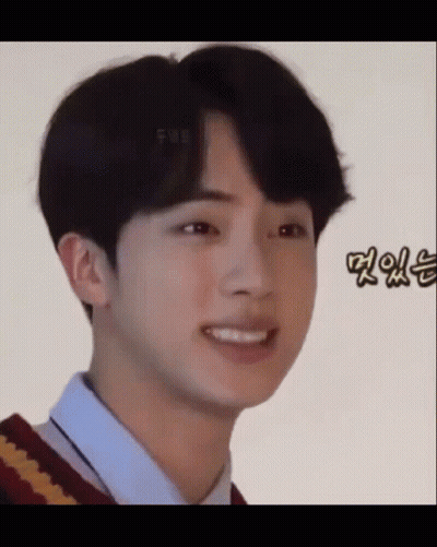A Close Up Of A Young Man Making A Funny Face While Wearing A Sweater And A Shirt . GIF