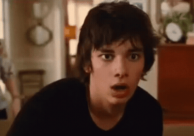 A Close Up Of A Young Man Making A Surprised Face In A Living Room . GIF