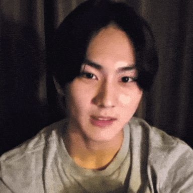A Close Up Of A Young Man 'S Face In A Grey Shirt GIF