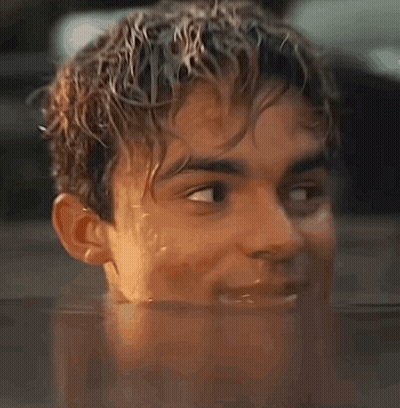 A Close Up Of A Young Man 'S Face In A Pool Of Water GIF
