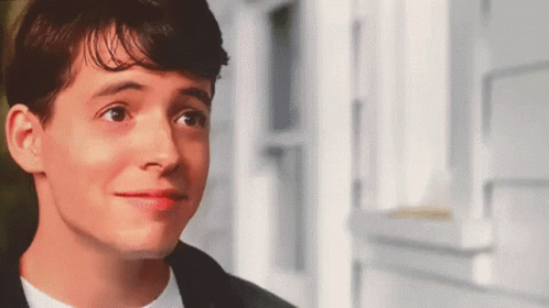 A Close Up Of A Young Man 'S Face Looking At The Camera . GIF