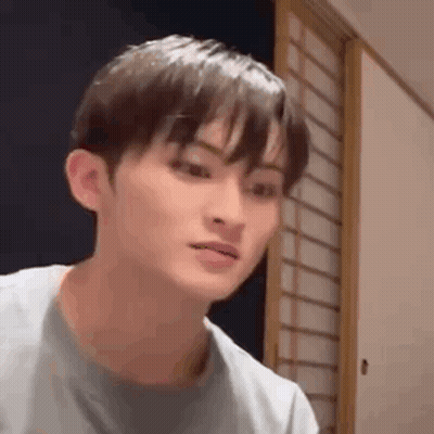 A Close Up Of A Young Man 'S Face Making A Funny Face In A Room . GIF