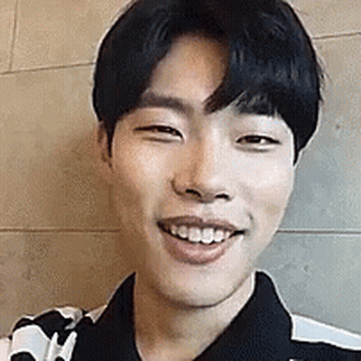 A Close Up Of A Young Man 'S Face Smiling . GIF