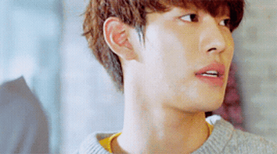 A Close Up Of A Young Man 'S Face Wearing A Grey Sweater GIF