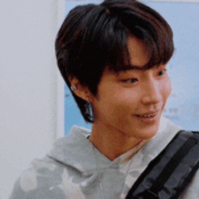 A Close Up Of A Young Man 'S Face With A Backpack GIF
