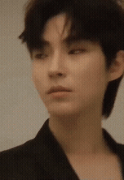 A Close Up Of A Young Man 'S Face With A Black Jacket On . GIF