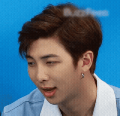 A Close Up Of A Young Man 'S Face With A Blue Background GIF