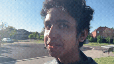 A Close Up Of A Young Man 'S Face With A Blue Sky In The Background GIF